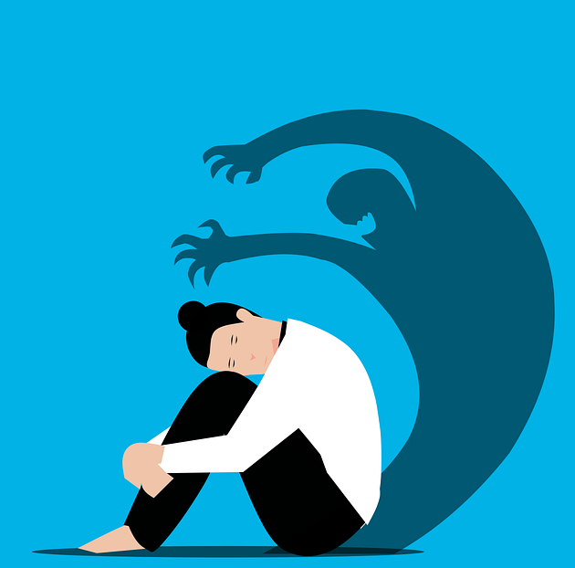 Cartoon of woman curled up, sad with an anxiety shadow behind her